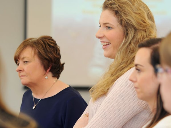 Members attending a course engaged in conversation and learning 